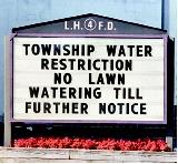 A sign warns residents that they may no longer water their lawns because of drought conditions. Lack of rain in conjunction with high temperatures can lead communities and even states to enact water-use restrictions in an attempt to control water demand.