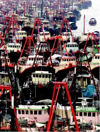 Overfishing can lead to regulatory closures of fisheries. Hundreds of fishing boats sat idle in Hong Kong's Aberdeen Harbor in 2000 during a 2-month fishing ban in the South China Sea. The ban stemmed from years of overfishing that depleted fish stocks and decreased fishers' incomes.