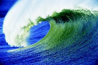 The classic curl of a breaking wave is associated worldwide with surfing. As a wave approaches shore, friction slows the bottom of the wave while allowing the top to continue moving, which causes the top to lean forward in this manner.